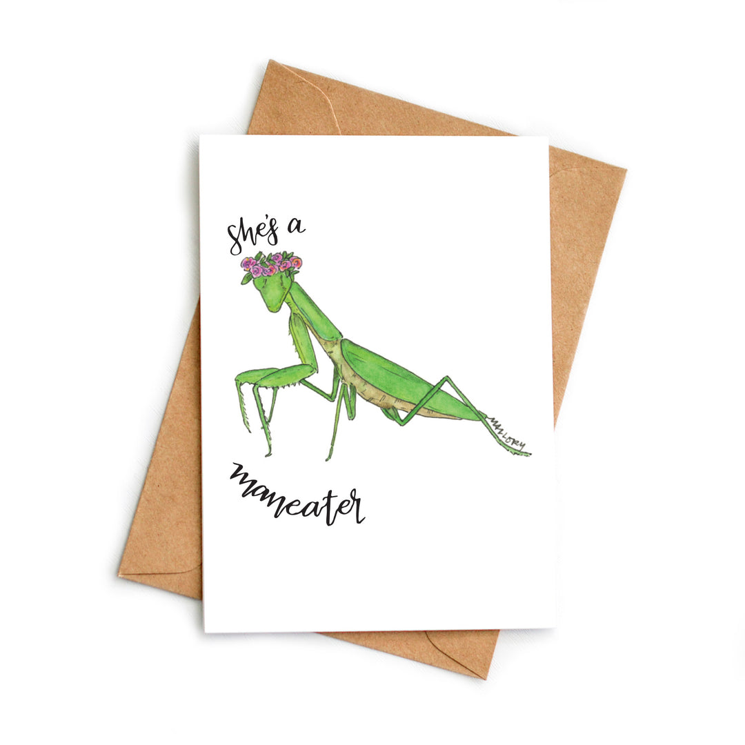 Card with a green praying mantis illustration and text 'She's a mameater' on a white background with a brown envelope.