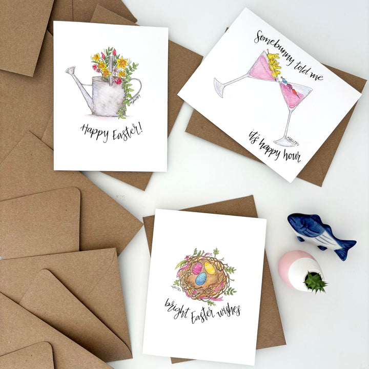 Three Easter greeting cards with envelopes on a white surface