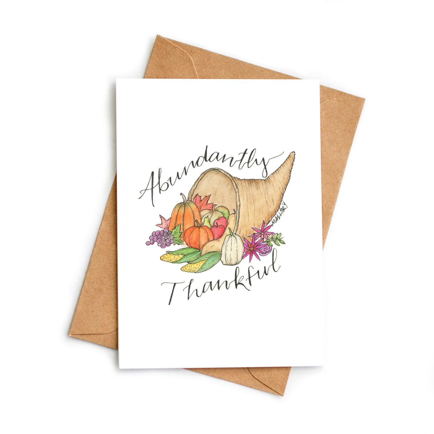 Thanksgiving card with a cornucopia filled with fresh pumpkins and vegetables in orange, green purple and natural colors. The words, "Abundantly Thankful" are depicted on the Thanksgiving card.