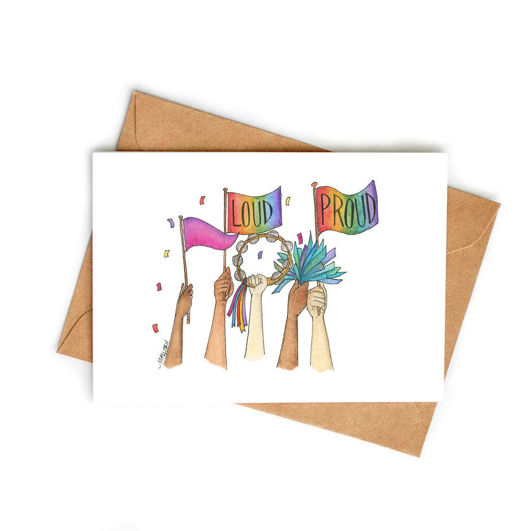 Image depicts a fun Pride Parade card with hands up in the air holding Pride flags, a tambourine and blue pom poms. The words, "Loud" and "Proud" are lettered on the pride flags.