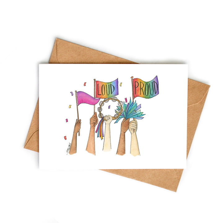 Image depicts a fun Pride Parade card with hands up in the air holding Pride flags, a tambourine and blue pom poms. The words, "Loud" and "Proud" are lettered on the pride flags.