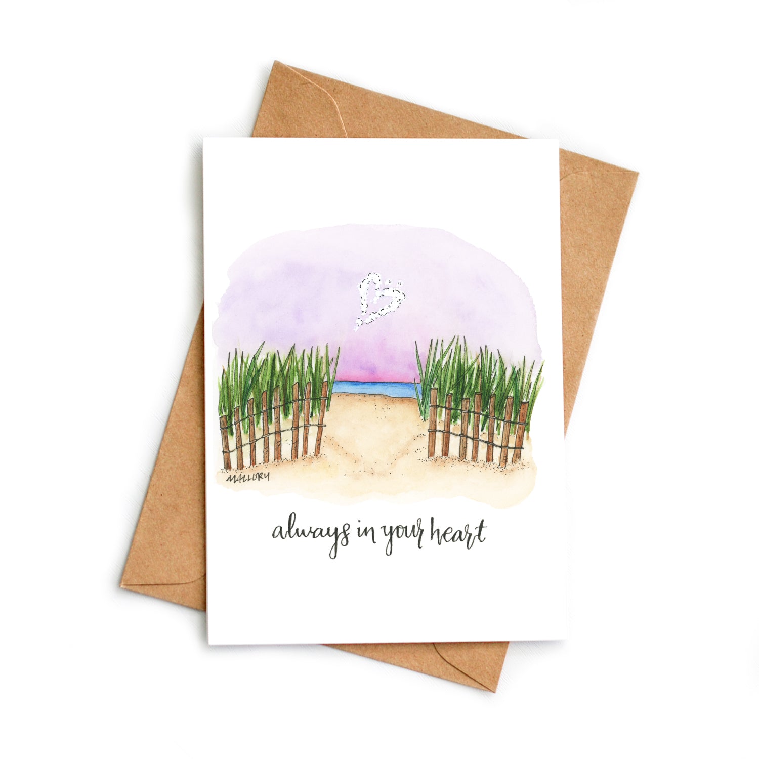 Sympathy card with grassy dunes and the setting sun in a purple sky with the blue ocean below. A cloud in the shape of a heart is above with the words, "always in your heart" hand-lettered on the sympathy card.
