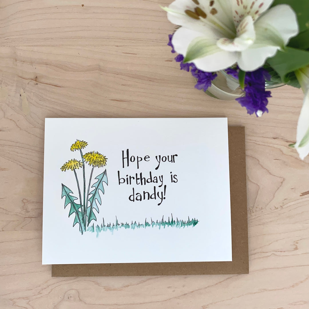 Image of a birthday card with yellow dandelions and the words, "Hope your birthday is dandy!" are hand-lettered on the card.