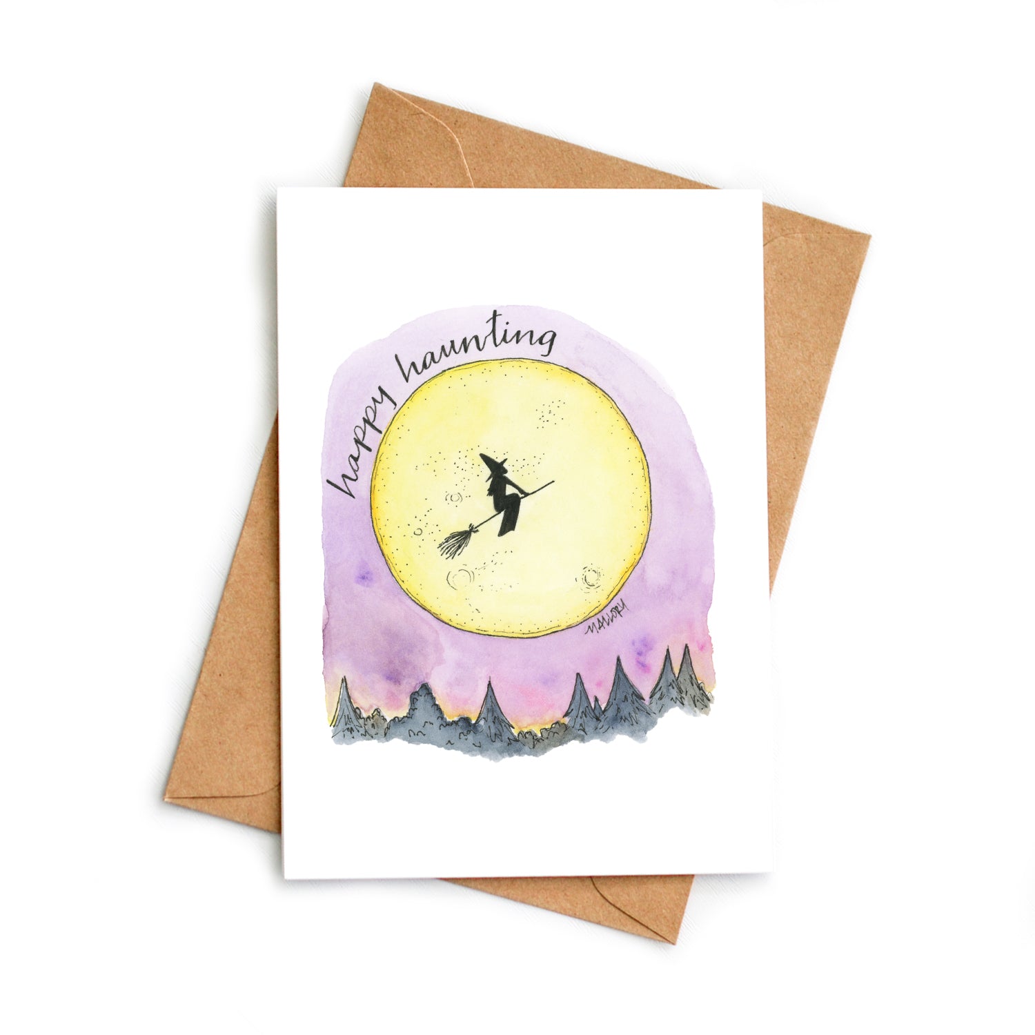 Halloween card with a full yellow moon against a purple night sky and the silhouette of a witch riding a broom. The words, "happy haunting" are hand-lettered on the card.