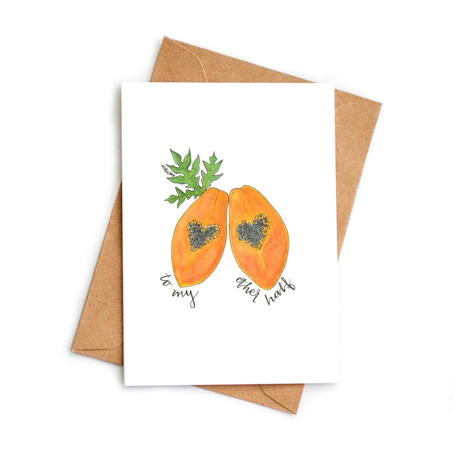 Image depicts a Valentine's Day card with an orange papaya that is sliced open with the black papaya seeds in the shape of a heart. A papaya leaf is behind the papaya and the words, "to my other half" are hand-lettered below.